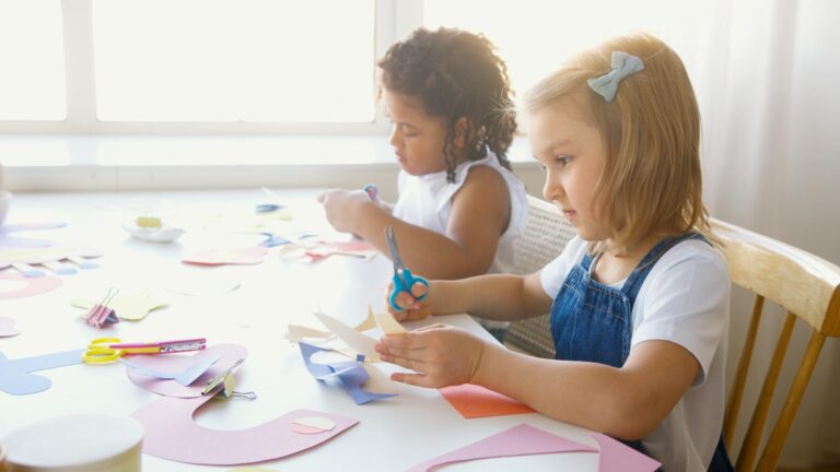 Young children enjoying a fun and educational paper craft activity indoors.